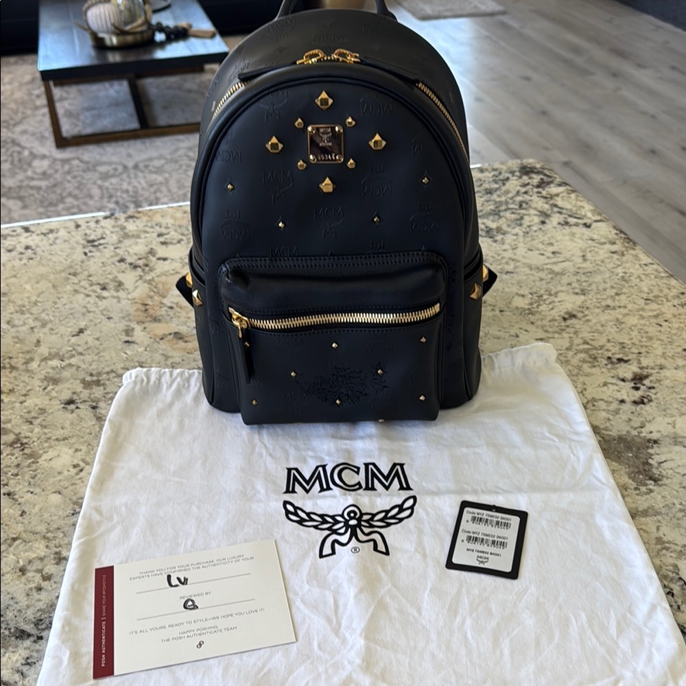 MCM Black Backpack with Gold-Tone Accents and Leather Finish